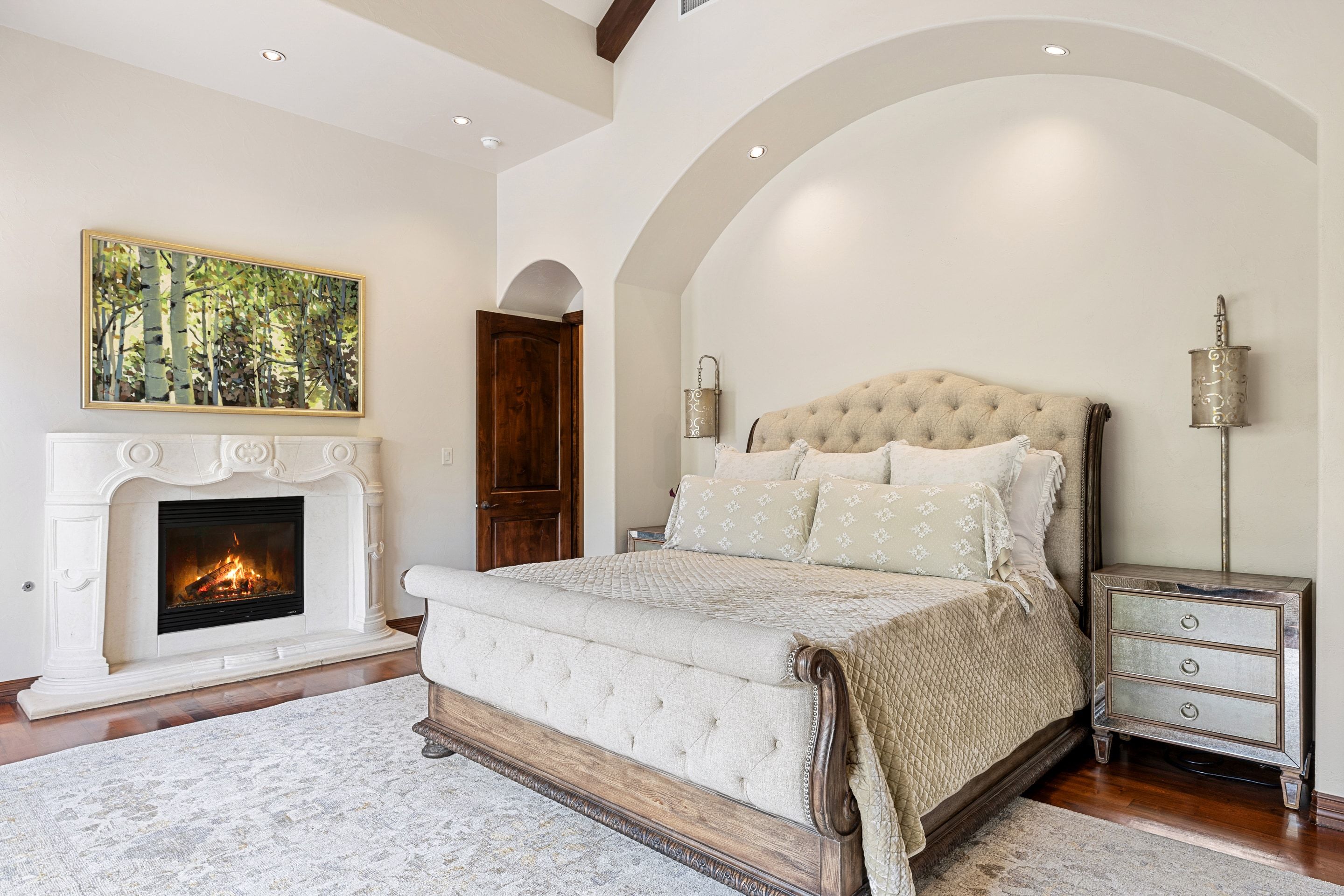 Primary bedroom at Lakehaven with fireplace and arched ceiling